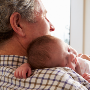 Legacy 3 Grandfather contemplating his legacy while holding a sleeping infant