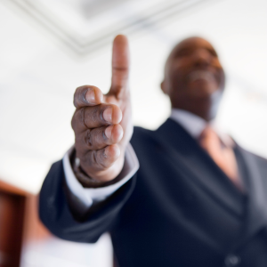 African American male extending hand for a handshake, inviting business partner opportunity with the Hope School Foundation
