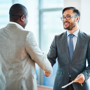 Man and woman business partners shaking hands on an in-kind donation deal